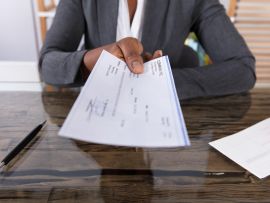 Lady handing over a paycheck