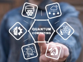 Man using virtual touchscreen with "Quantum Computing" on it.