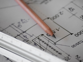 An architect's plans with a ruler and pencil.